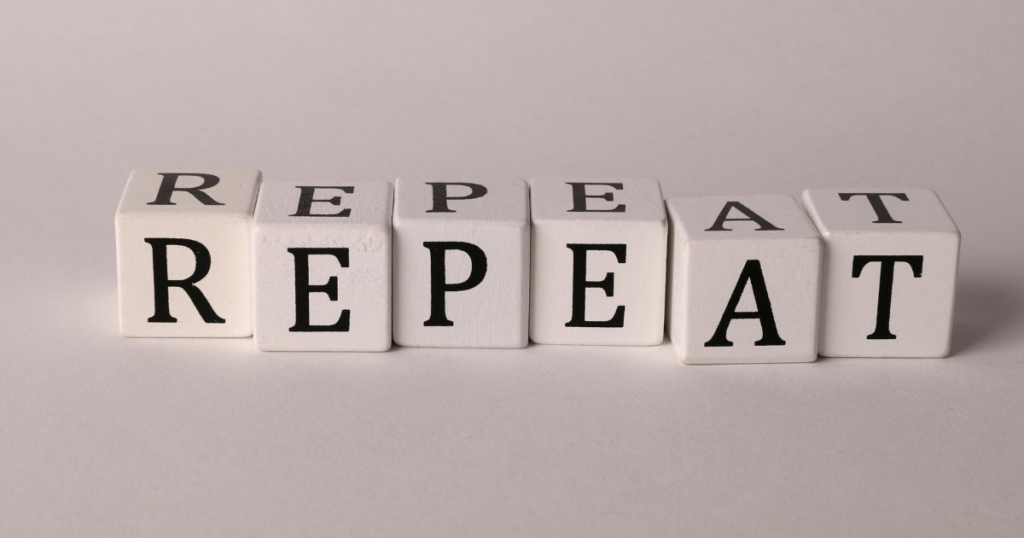 White letter blocks arranged in a row spell REPEAT twice, illustrating repetition.